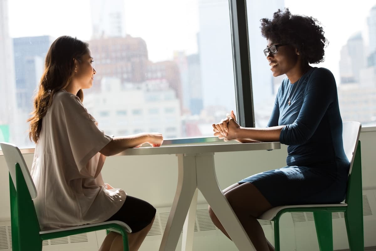 A calm conversation by a window overlooking the New York City skyline